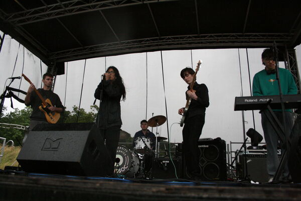 Students performing on a stage outside 